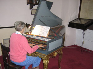 Gena Churchill playing the harpsichord